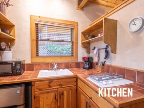 This cozy kitchen is equipped with everything you need for preparing your favorite meals. From morning coffee to dinner, you'll find the essentials here to make your stay comfortable and conve