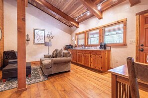 Effortless elegance meets practicality in this cozy living space. Enjoy the perfect blend of style and functionality, with a spacious table just steps away for leisure.
