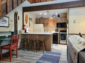 Kitchen, dining and living are in an open lofted space. Sleeping loft is above