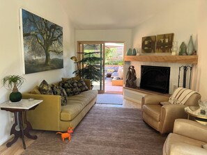 Living room, and primary bedroom, open to fabulous deck with water feature.

