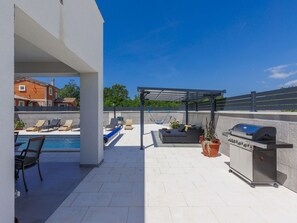 Sky, Plant, Shade, Flowerpot, Urban Design, Outdoor Furniture, Real Estate, Gas, Roof