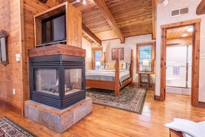 Cozy nights and peaceful slumbers await in this enchanting sanctuary, where the flickering flames of the fireplace dance in harmony with the comfort of your bed.