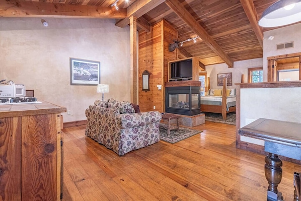 Experience ultimate comfort and coziness in this all-in-one sanctuary, where the warmth of the fireplace complements the allure of the bed, creating a haven for relaxation and tranquility.