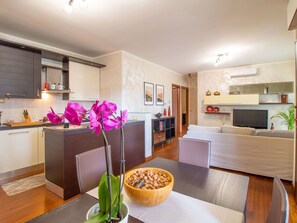 Furniture, Table, Cabinetry, Countertop, Tableware, Kitchen, Lighting, Interior Design, Orange, Houseplant