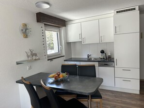 Furniture, Countertop, Kitchen, Kitchen Appliance, Interior Design, Cabinetry, Flooring, Wood, Major Appliance, Floor