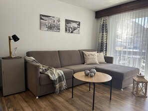 Furniture, Interior Design, Flooring, Couch, Floor, Wood, Living Room, Room, Table, Home