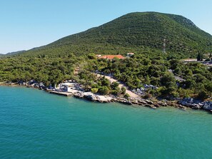Water, Mountain, Sky, Water Resources, Building, Azure, Natural Landscape, Tree, Coastal And Oceanic Landforms, Lake
