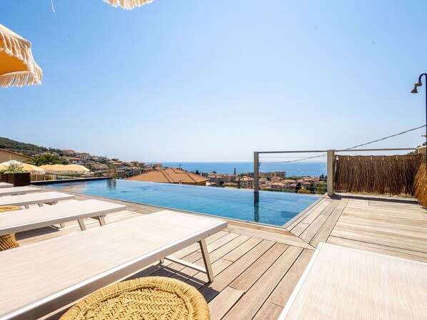 Sky, Water, Property, Azure, Swimming Pool, Seaside Resort, Shade, Outdoor Furniture, Wood, Building