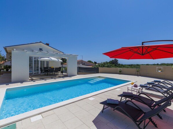 Water, Sky, Plant, Building, Swimming Pool, Shade, Outdoor Furniture, Sunlounger, Umbrella, Tree