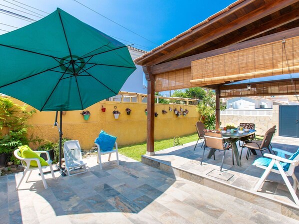Plant, Table, Property, Furniture, Flowerpot, Building, Umbrella, Azure, Chair, Shade