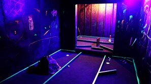 Experience the thrill of our glow-in-the-dark mini golf room!
