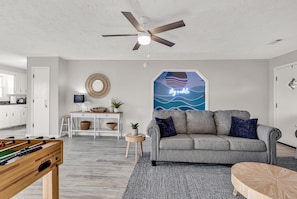 Living room opening up to kitchen area