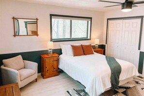 Cozy comfort beckons in our bedroom oasis, complete with bedside lamps and a plush couch.