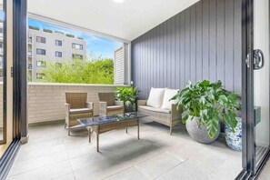 Large open private balcony with exercise bike and BBQ
