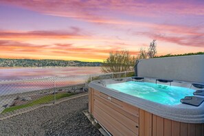 Soak the day away in the hot tub overlooking the water