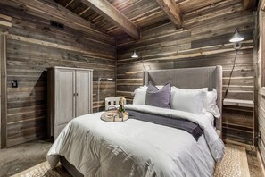 Welcome to your cozy queen bed retreat equipped with a plush queen bed, adorned with crisp linens and fluffy pillows for a restful night's sleep. Check out our handy Armoire, ready to keep your things organized!