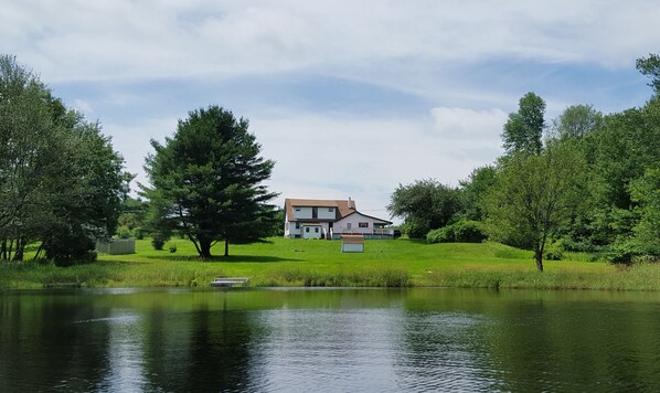 Spectacular view of the home from the tranquil lake