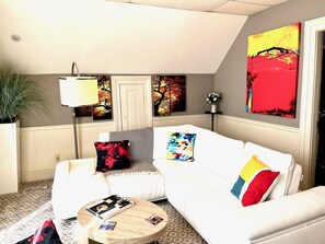 Another view of living room leather sofa with art on the walls