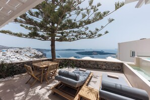 Balcony with sun loungers, seating area and sea view
