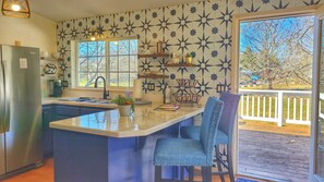 Bar top seating to keep tabs on the chef! Cute kitchen.
