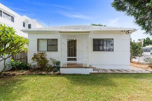 This charming white cottage embodies relaxed coastal living, footsteps from Corrimal Beach.
