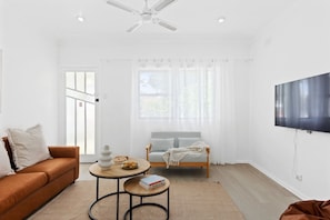 Get comfortable in the living room with a wall-mounted TV for movie nights at home.
