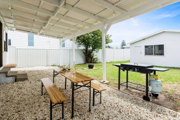 Dine alfresco on the covered gravel patio. There’s a BBQ, fire pit and ample seating to enjoy the coastal breezes.
 
