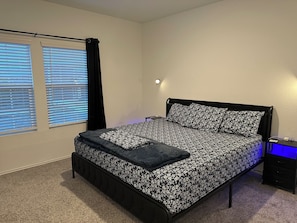Luxurious bedroom with king-size bed & convenient remote-controlled night lamps.