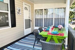 Covered private patio with outdoor table and seating