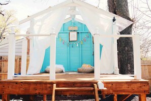 Play house in the fenced in yard.
