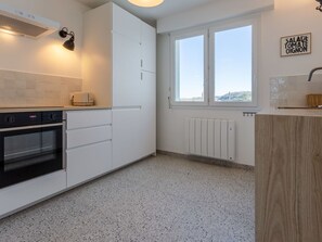 Cabinetry, Countertop, Building, Window, Kitchen, Lighting, Wood, Kitchen Appliance, Flooring, Interior Design