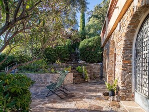 Plant, Outdoor Furniture, Tree, Building, Shade, Window, Door, Road Surface, Sky, Landscape
