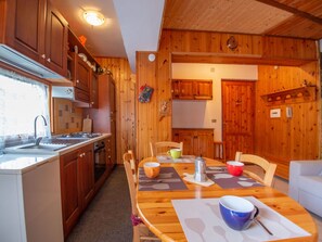 Cabinetry, Property, Furniture, Table, Wood, Kitchen, Orange, Tableware, Interior Design, Chair