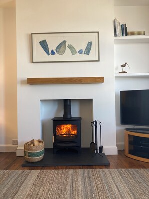 Living room with log burner for use in the winter months.