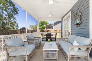 Outdoor comfort at its best! Our inviting backyard porch features a cozy sofa, perfect for lounging and enjoying the fresh air in style.