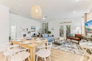 Our living room, complete with a dining table and chairs, sets the stage for cherished family dinners and meaningful conversations
