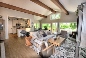 Beautiful and comfortable living room with wood stove. Open, bright and airy. Gorgeous vaulted ceilings with beam accents