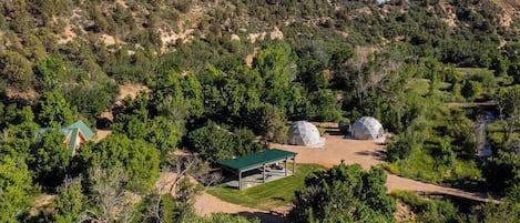 Ariel view of Zen Zion featuring River Dome and Evergreen Dome (you can also see the rooftops of Honeybee and Hummingbird cabins as well as the shared pavilion)