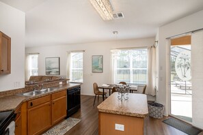 The open, airy kitchen offers ample space & all the comforts of home