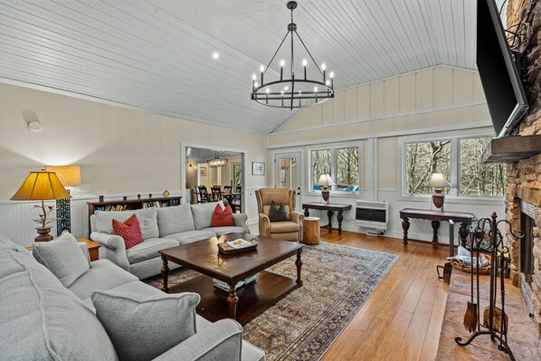 Living Room with wood burning fireplace and TV