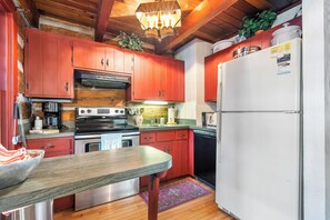Cozy kitchen is well equipped including a coffee grinder and grill utensils