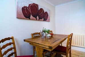 Dining area in kitchen with wooden table and four chairs