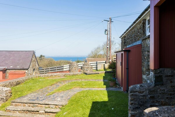 Front of cottage with distant sea views