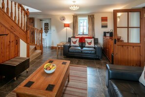 living room area with double leather sofas, foot stool and coffee table