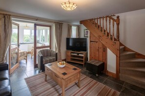 Armchair, Flat screen TV. Coffee table, rug