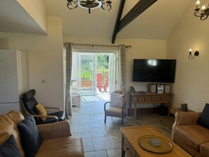 Patio doors leading from the sitting room to the conservatory