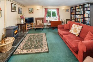 Lounge with sofa, tv, woodburner, armchair, dining table