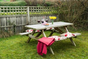 Rear large enclosed garden with picnic bench