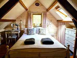 King size bed, bedside table with wall lights. Chest of drawers and vanity table and chair