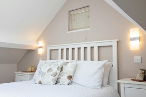 Double bed, pillows, bedside cabinet and lamps